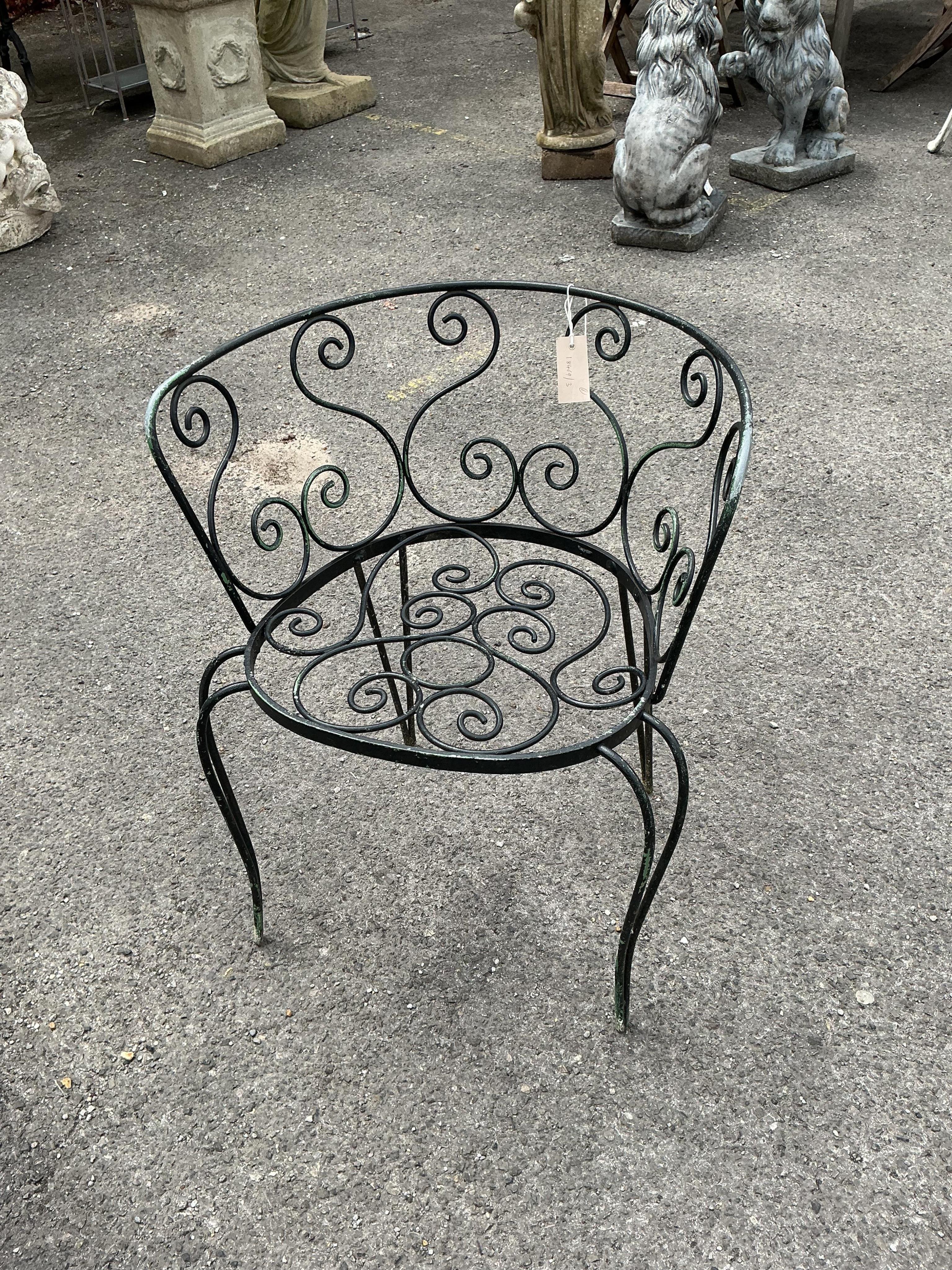 A circular stone mosaic topped garden table, diameter 80cm, height 72cm and six wrought iron garden chairs